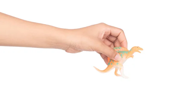 Руки тримають спінозавра з пластику. Ізола динозаврів. — стокове фото