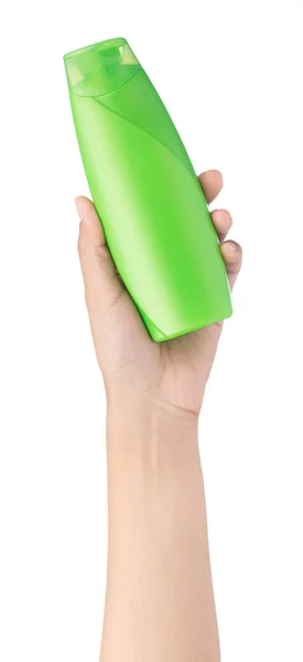हाथ में सफेद बी पर अलग शैम्पू की ग्रीन प्लास्टिक की बोतल पकड़े हुए — स्टॉक फ़ोटो, इमेज