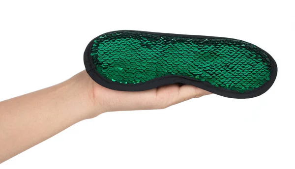 Hand holding Green sleeping eye mask with sequins that look like — 图库照片