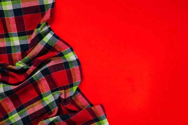 Red checkered tablecloth on red background — 图库照片