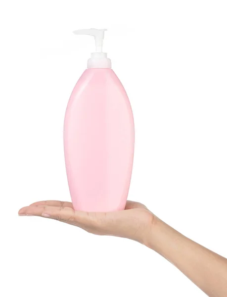 Mano sosteniendo botella de plástico rosa con bomba aislada en bac blanco —  Fotos de Stock