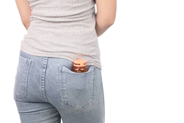 Back view of female with bottle of pill in jeans pocket isolated — 图库照片