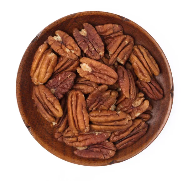 Wood dish of pecan nuts isolated on white background — Stockfoto