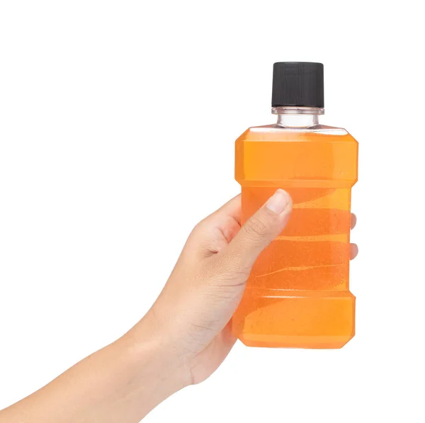Hand holding bottle of mint orange mouthwash isolated on white b — Stok Foto
