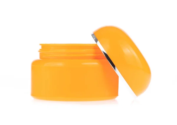 Frasco recipiente creme cor de laranja isolado no fundo branco — Fotografia de Stock