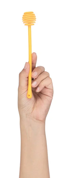 Ręka trzyma miód dipper izolowane na białym tle — Zdjęcie stockowe