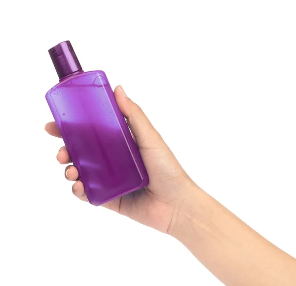 Ruka drží láhev kosmetický přípravek pro péči o pleť izolované na — Stock fotografie