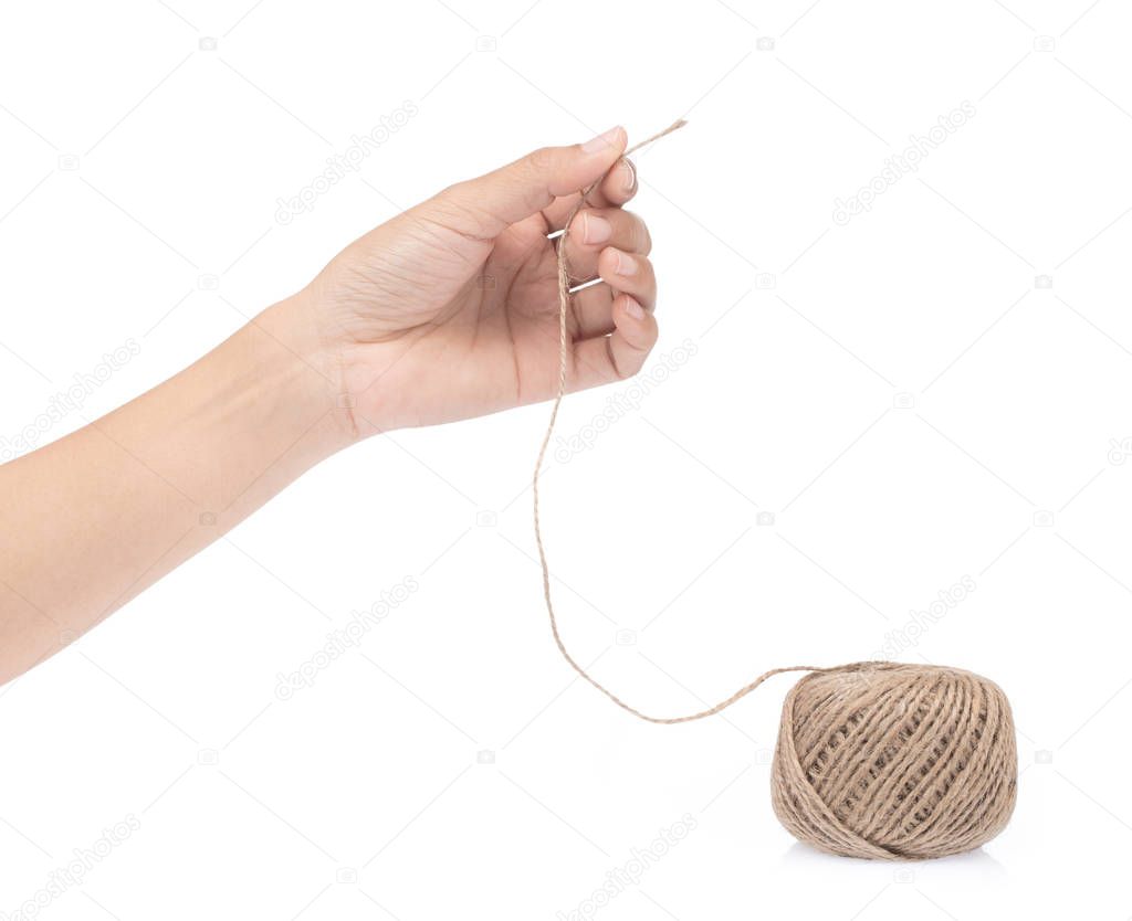 hand holding wool yarn isolated on a white background.