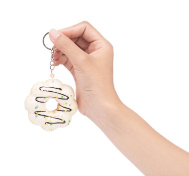 hand holding key chain Donut isolated on white background.