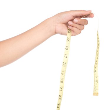hand holding Measuring tape of the tailor for design isolated on