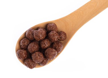 Cereal chocolate balls on spoon isolated on white background