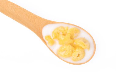 Cereal with milk on wood spoon isolated on white background.