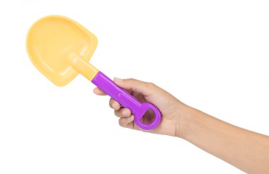 hand holding plastic tool shovel of beach toy isolated on white 