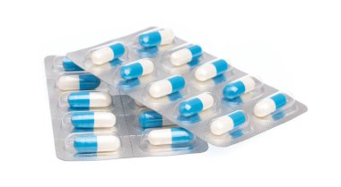 A panel of blue capsules medicine isolated on white background.