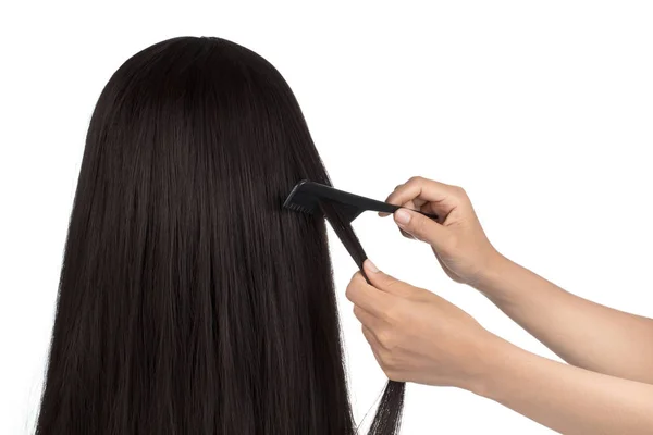 Hairdresser does hair with black comb of the girl with long hair — Stok fotoğraf