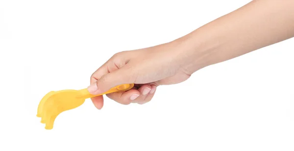 Mão segurando pequeno ancinho de brinquedo de plástico isolado em um backgrou branco — Fotografia de Stock