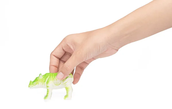 Mão segurando rinoceronte feito de plástico. brinquedo animal isolado — Fotografia de Stock