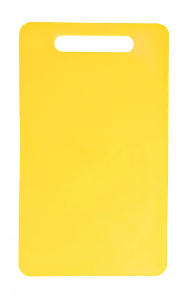 Желтая пластиковая разделочная доска на белом фоне — стоковое фото