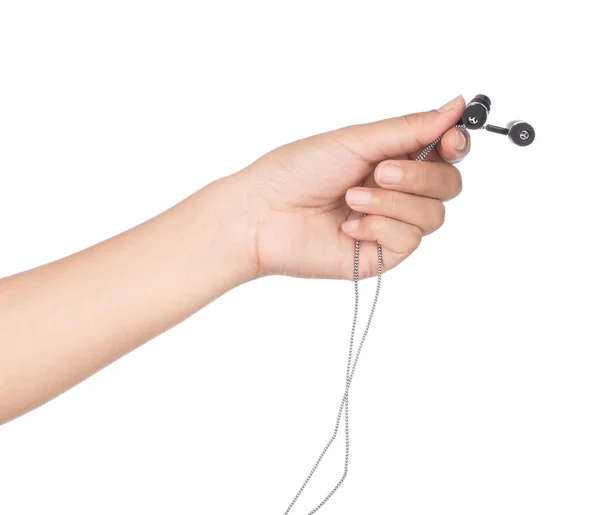 Mão segurando fones de ouvido isolados em um fundo branco — Fotografia de Stock