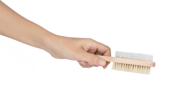 Hand holding brush with stone scrub foot hygiene tool isolated o — Stockfoto