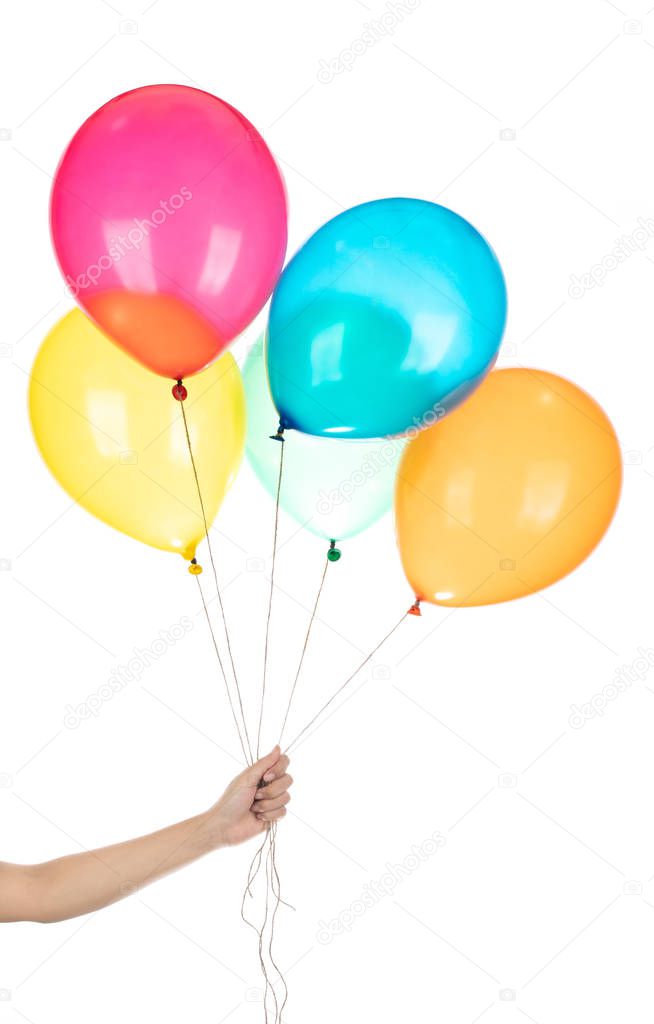 Hand holds colorful balloons isolated on a white background.