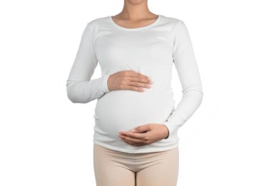 Young pregnant woman embracing her naked abdomen with hands. iso