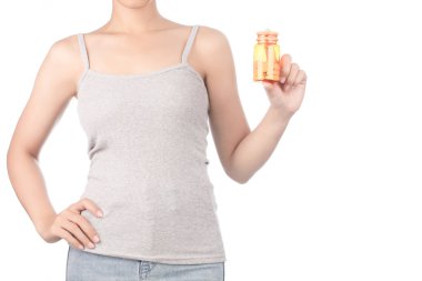 woman in grey tank top and jeans holding bottle of pills isolate