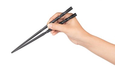hand holding wood black of chopsticks isolated on a white backgr