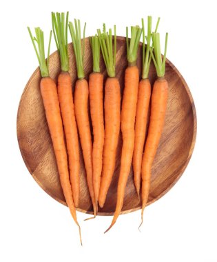 fresh baby carrots on wood dish isolated on white background