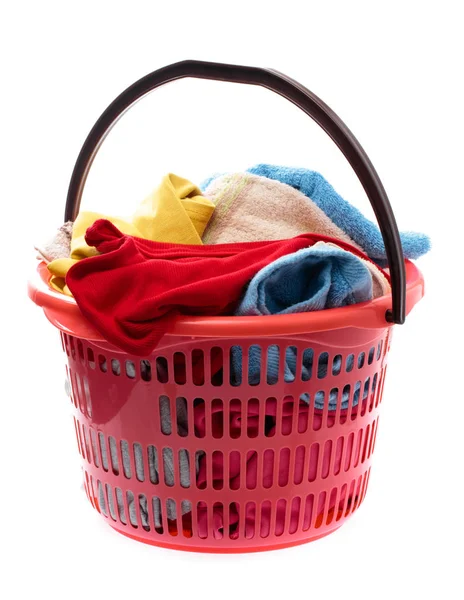 Colorful clothes in a red laundry basket isolated on white backg — ストック写真