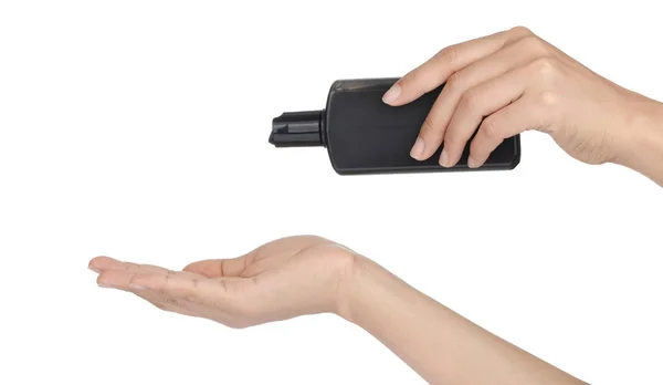 Рука тримає пляшку гелю для очищення ізольовано на білому фоні — стокове фото