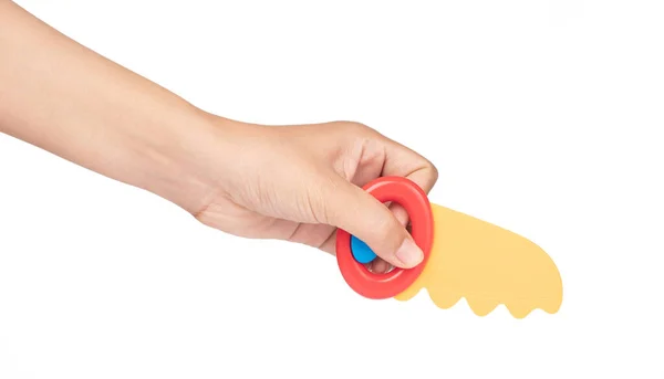 Hand holding toy of saw plastic isolated on a white background — Stock Photo, Image