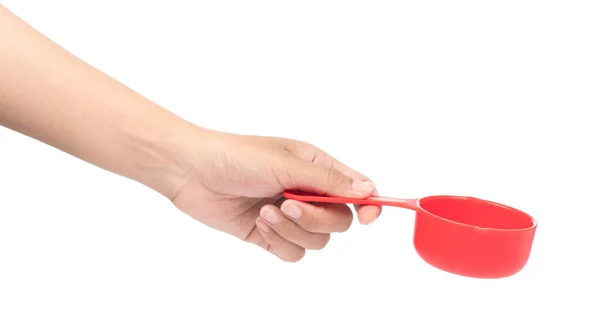 Hand holding red plastic scoop isolated on white background — ストック写真