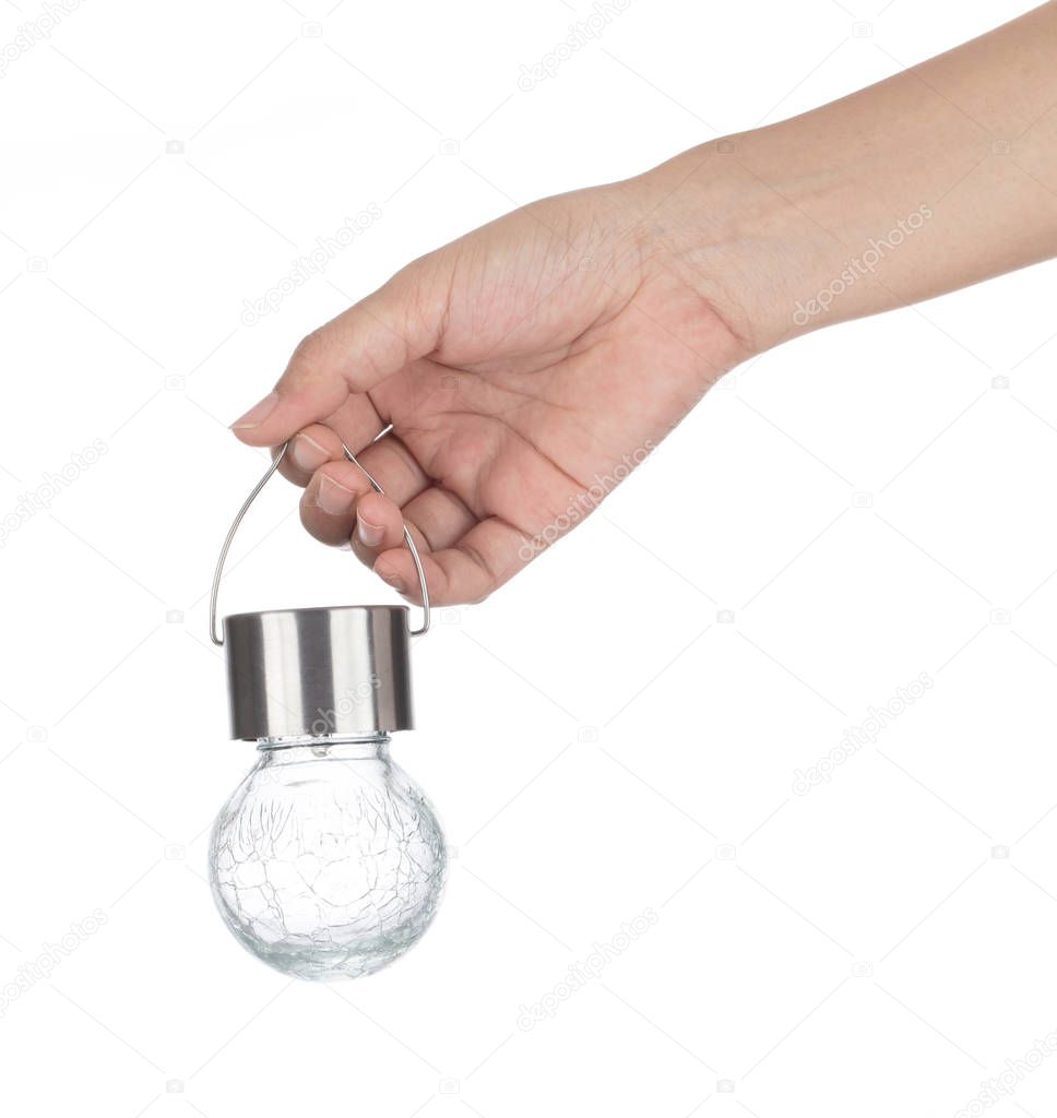 Hand holding glass ball lamp isolated on white background