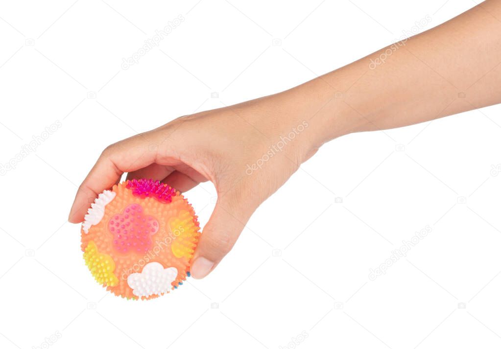 Hand holding Massage Rubber Ball with Spikes isolated on a white