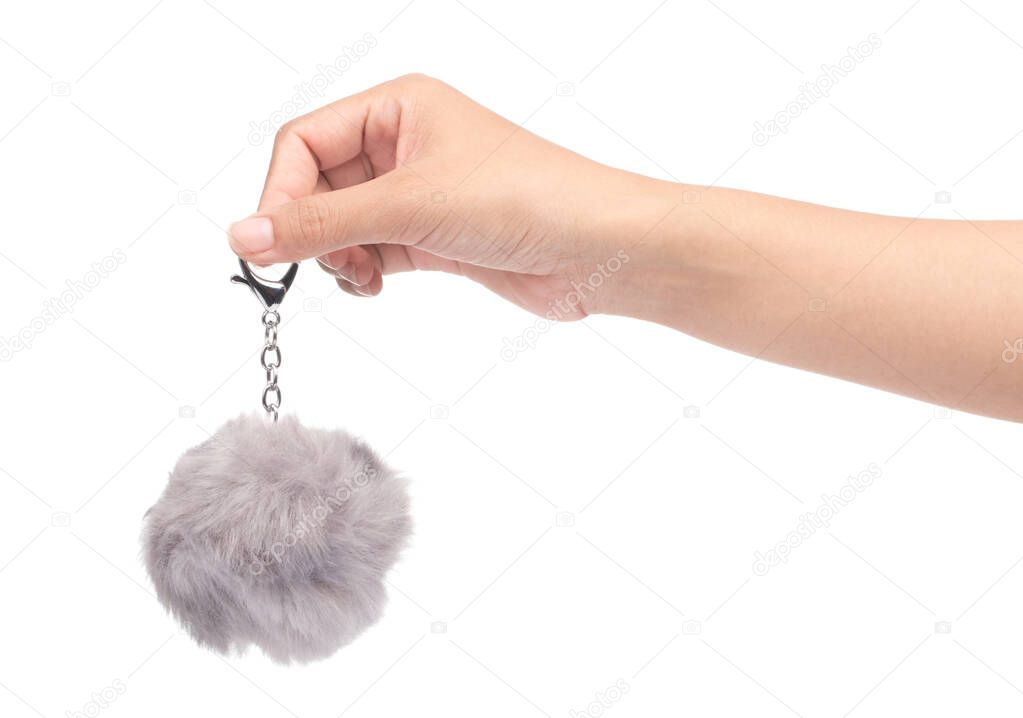 hand holding keychain Grey Fur ball isolated on white background