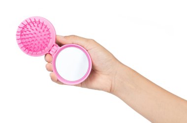 Hand holding Mini mirror with comb isolated on white background