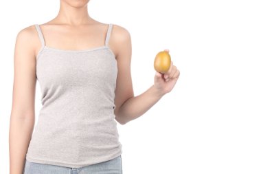 woman in grey tank top and jeans holding kiwi isolated on white 