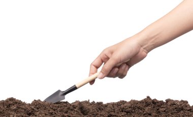 hand digging soil by shovel isolated on white background