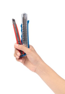 hand holding pair of blue and red cutters knife isolated on whit