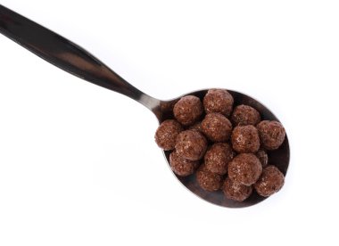 Cereal chocolate balls on spoon isolated on white background