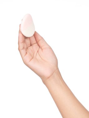 hand holding cosmetic sponges isolated on white background