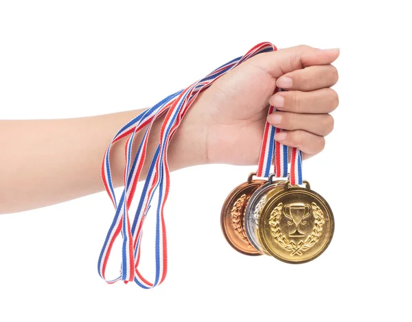 Mão segurando conjunto de medalhas premiadas isoladas em fundo branco . — Fotografia de Stock