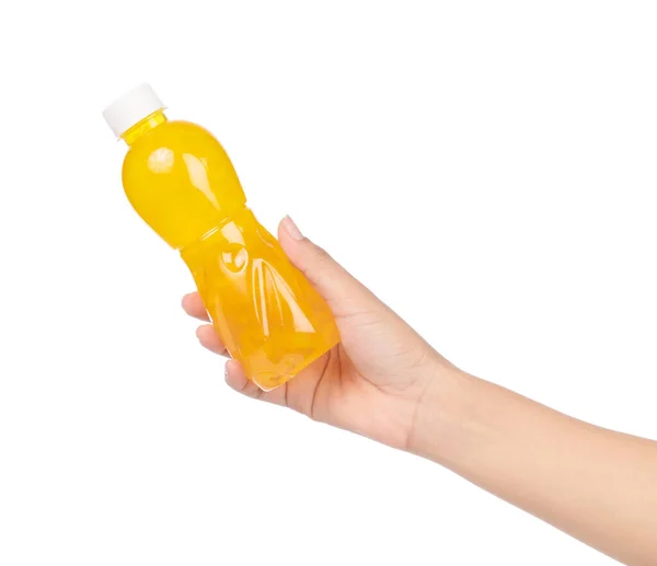 Ruční držení pomerančové šťávy v láhvi izolované na bílém pozadí — Stock fotografie
