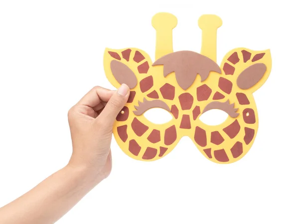 Hand holding giraffe animal carnival mask isolated on white back — 图库照片