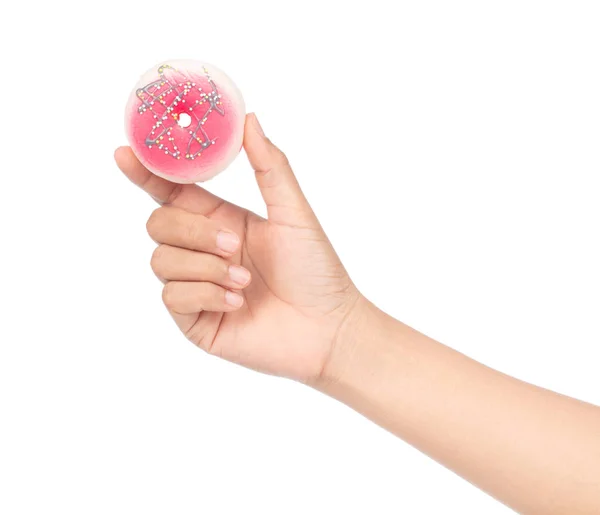 Mano sosteniendo una rosquilla con espolvoreos de colores aislados en blanco b — Foto de Stock