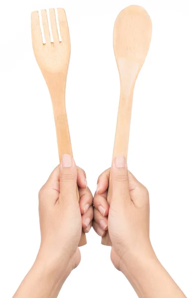 Mão segurando colher de madeira e garfo isolado no fundo branco — Fotografia de Stock