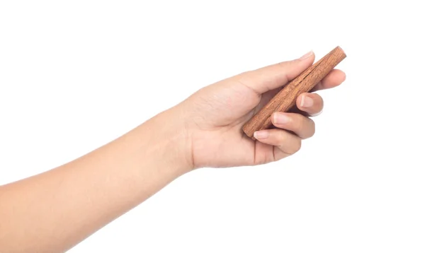 Hand holding cinnamon isolated on white background — Stock Photo, Image