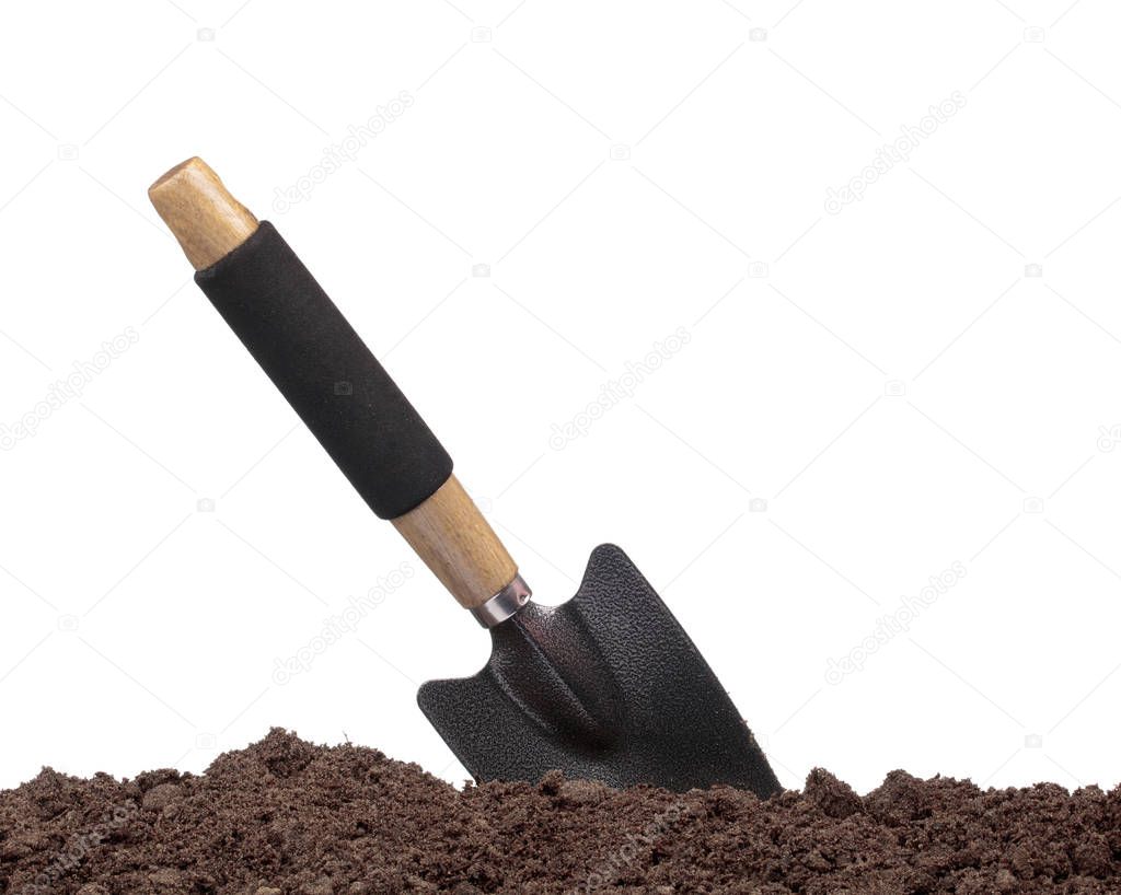 garden tools in soil isolated on white background