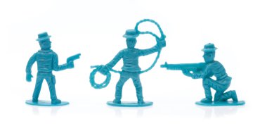 plastic toy cowboys isolated on white background